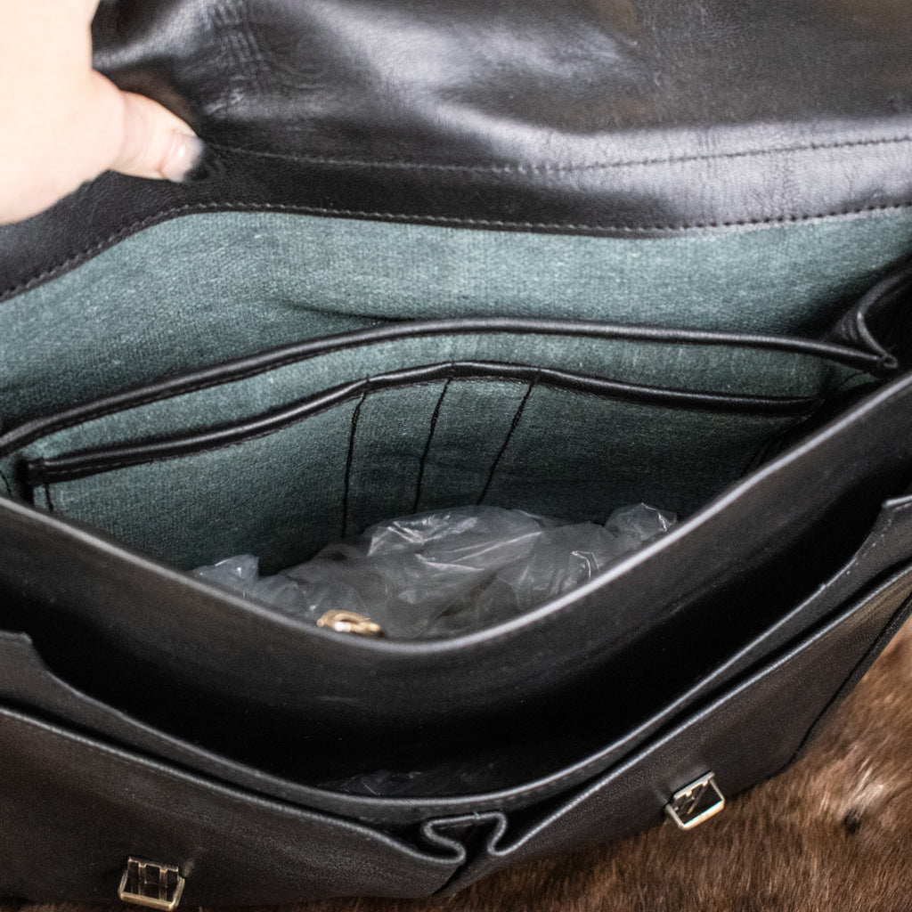 The inside of a black leather bag
