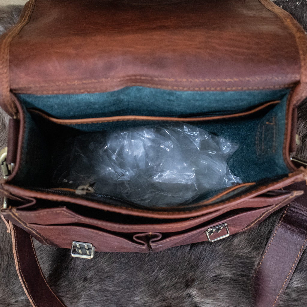 The inside of a brown leather bag