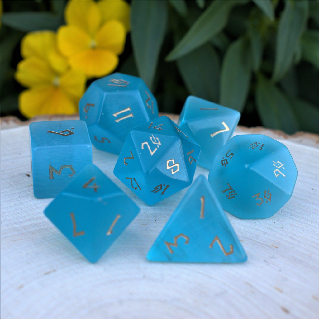 Blue cats eye dice set with gold numbers in a Nordic font
