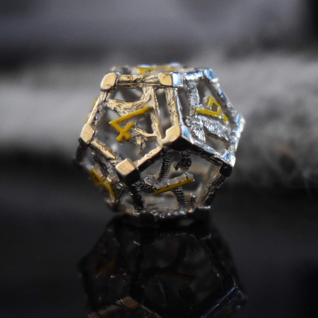 A hollow sterling silver die featuring yellow numbers in a Nordic font