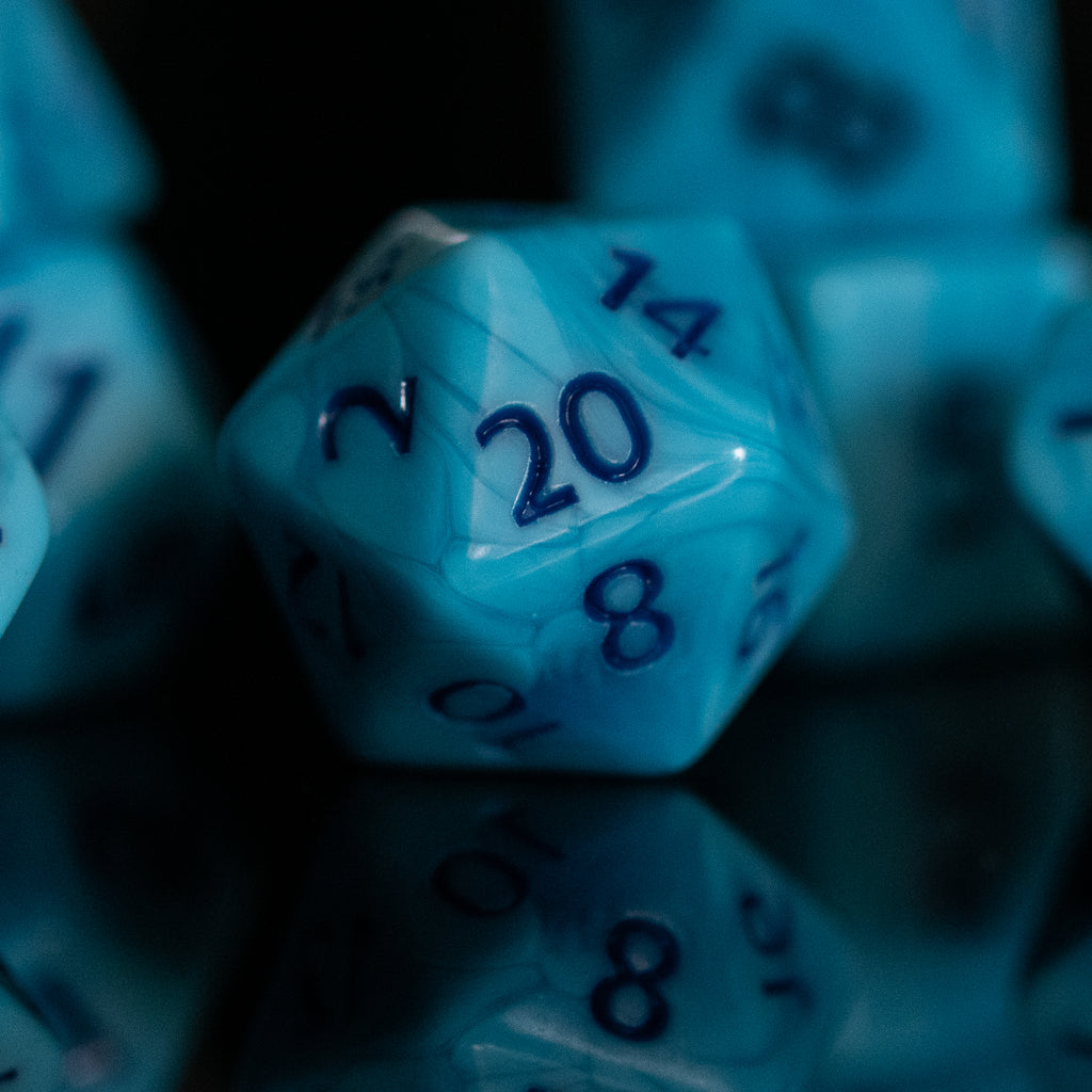Light blue acrylic dice with dark blue numbers