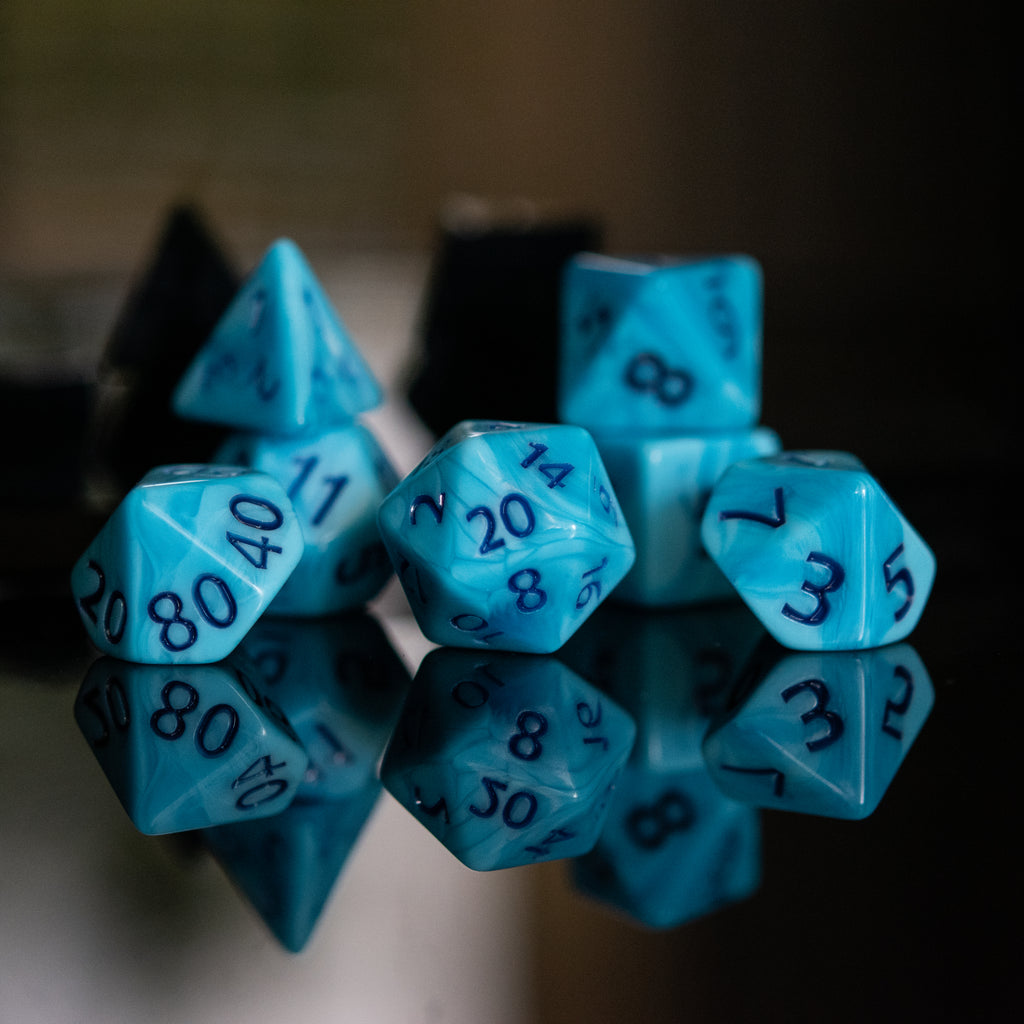 Light blue acrylic dice with dark blue numbers