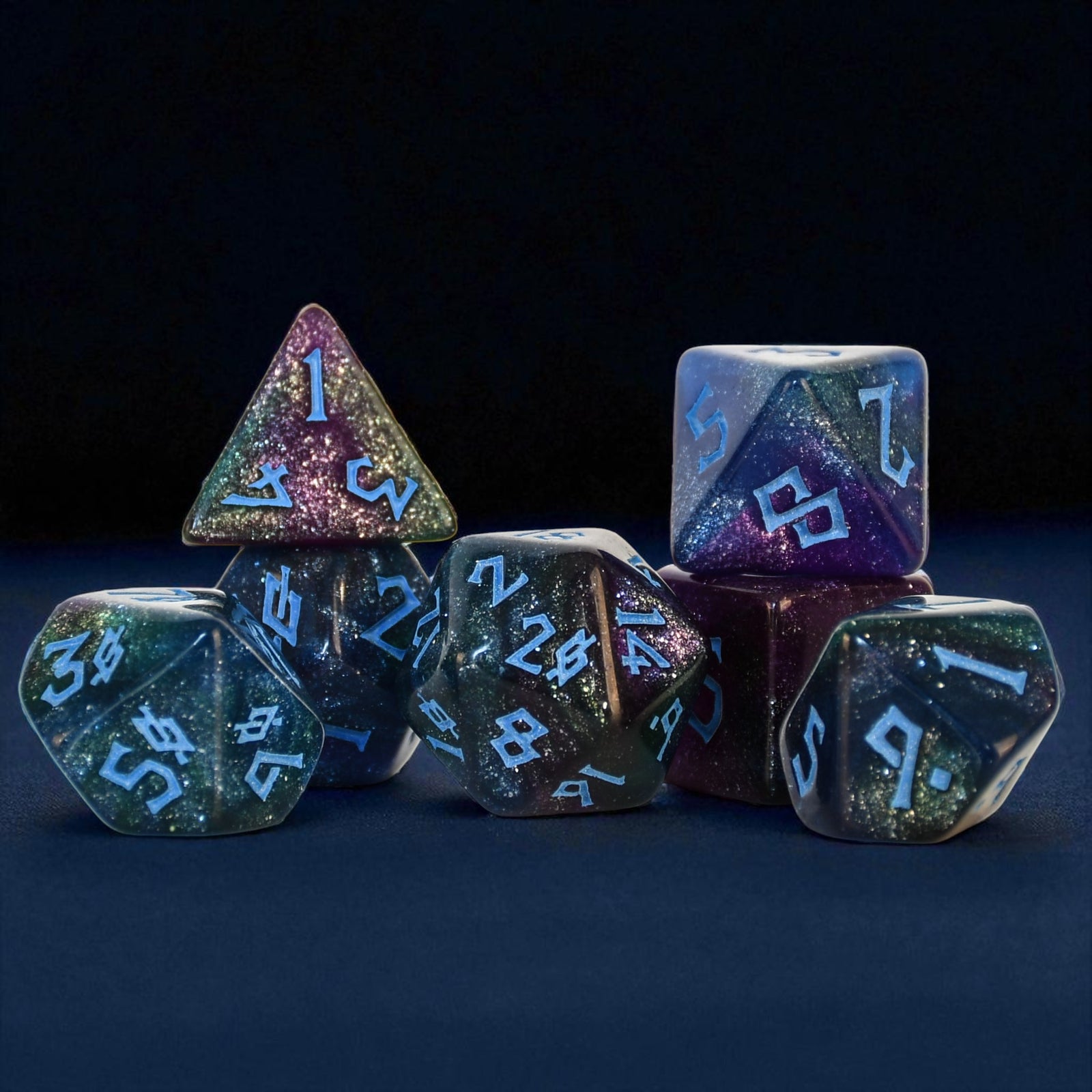 colorful shimmering set of 7 polyhedral acrylic dice with blue numbering