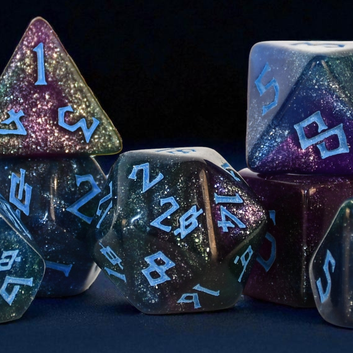 colorful shimmering set of 7 polyhedral acrylic dice with blue numbering
