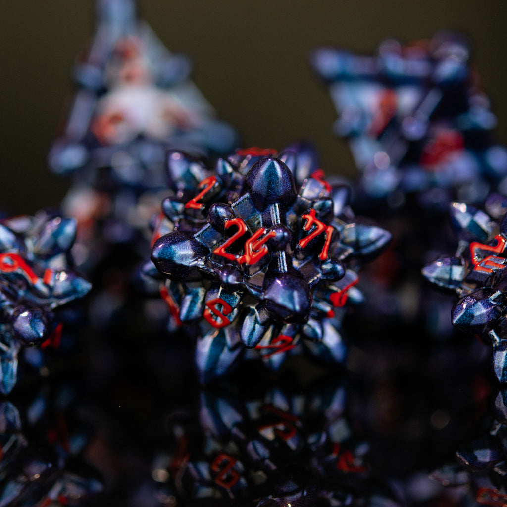 Spiky blue dice with red numbers in a Nordic font
