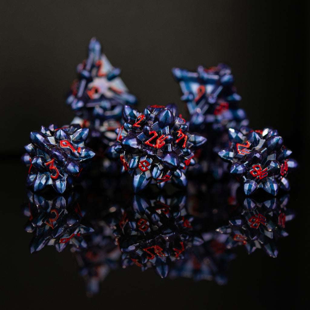 Spiky blue ttrpg dice with red numbers in a Nordic font