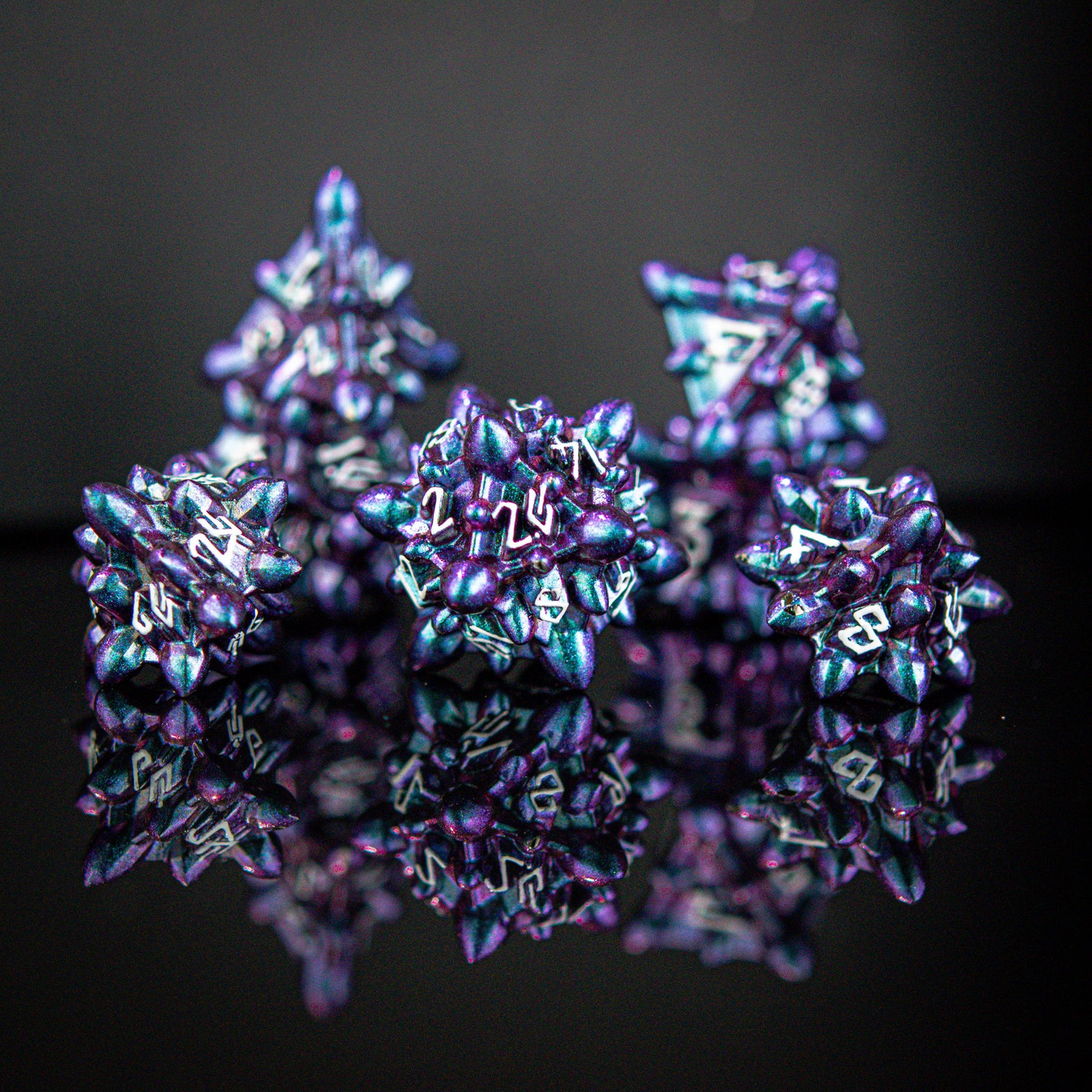 a purple and blue iridescent metal spiky asteroid like polyhedral dice set with white numbering