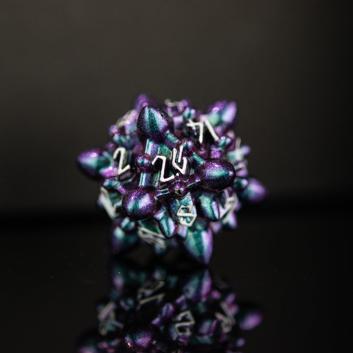 a purple and blue iridescent metal spiky asteroid like polyhedral dice set with white numbering