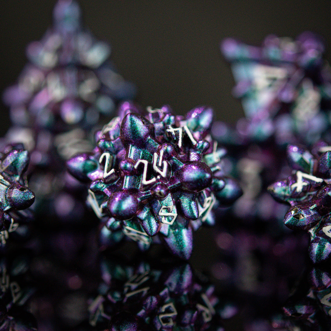 a purple and blue iridescent metal spiky asteroid like polyhedral dice set with white numbering
