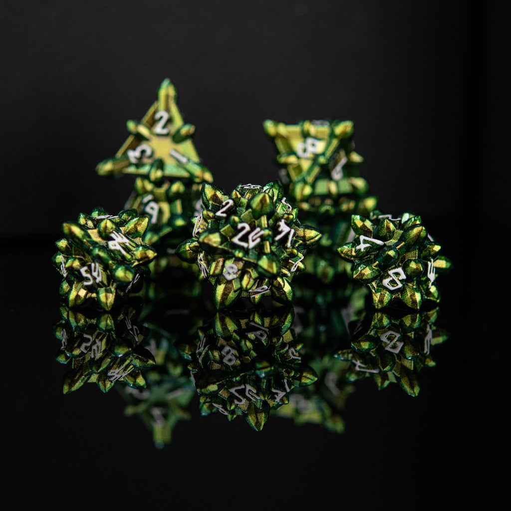 A set of green metal dice with embossed numbers, reflecting on a black surface, showcasing a unique extraterrestrial design.