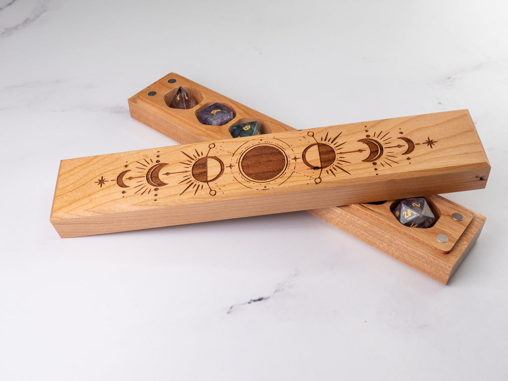Wooden dice tray with engraved designs on a white surface