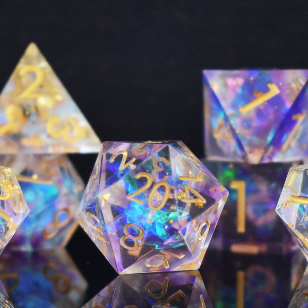 A set of clear sharp edge resin dnd dice with gold numbering and pastel neon iridescent foil inside for tabletop games and board games
