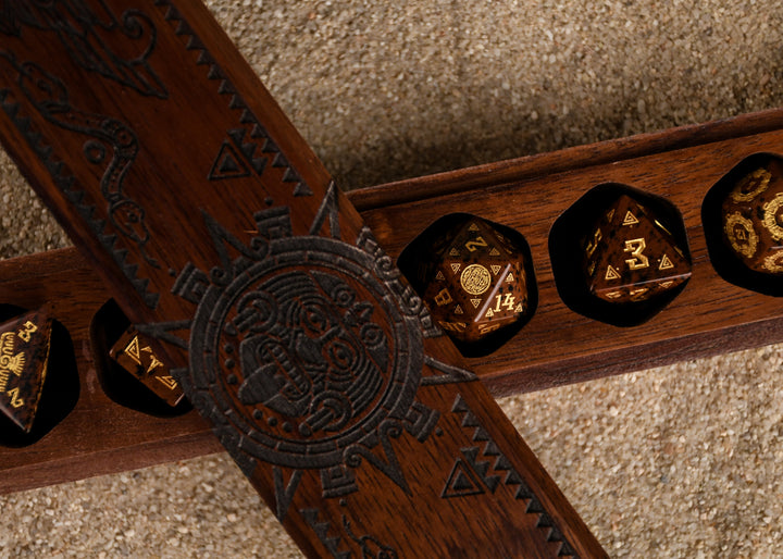 A set of hand-carved, Aztec Mahogany Obsidian Stone Dice with intricate Aztec designs in a wooden dnd dice vault box