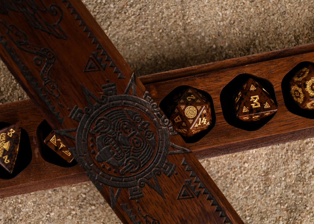 A set of hand-carved, Aztec Mahogany Obsidian Stone Dice with intricate Aztec designs in a wooden dnd dice vault box