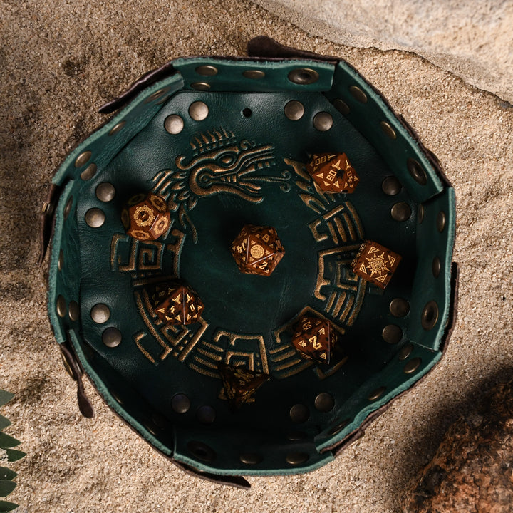 A set of hand-carved, Aztec Mahogany Obsidian Stone Dice with intricate Aztec designs in a leather dice tray