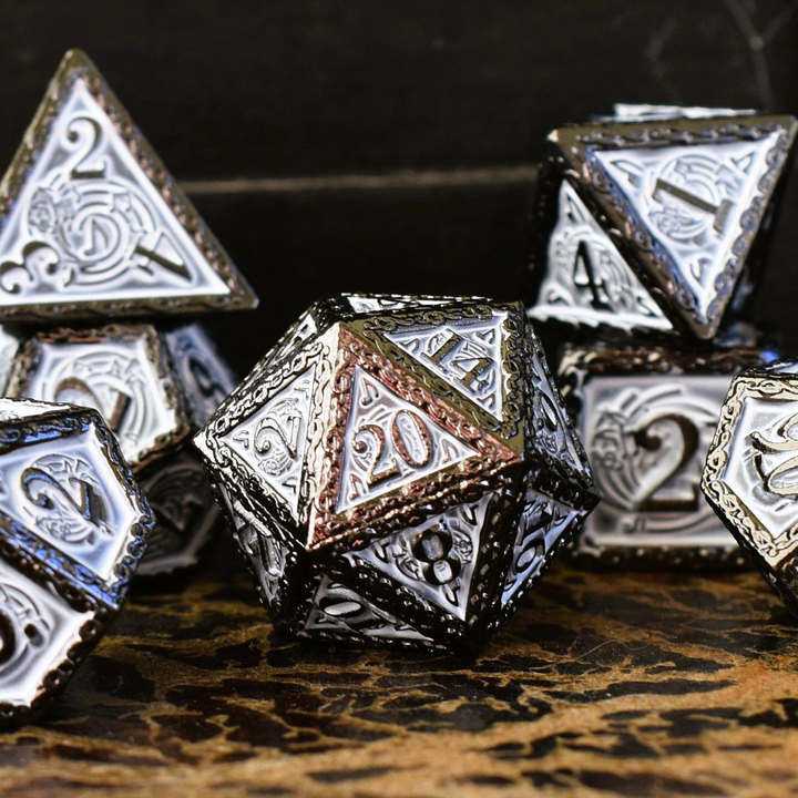 A set of white and gunmetal gray metal dice with musical note details around the gunmetal grey numbers on a wooden surface, including various shapes such as a d4, d6, d8, d10, d12, and d20.