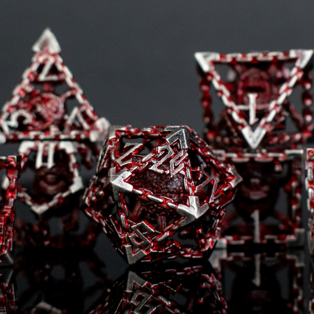 Silver and red hollow dice with beholders inside for tabletop gaming