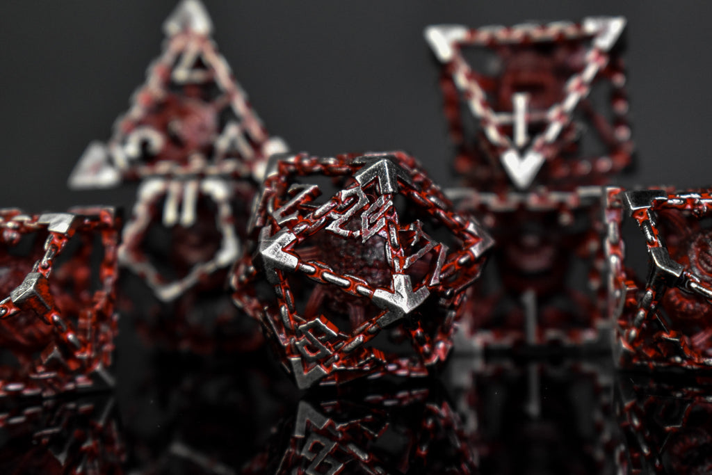 Silver and red hollow dice with beholders inside for tabletop gaming