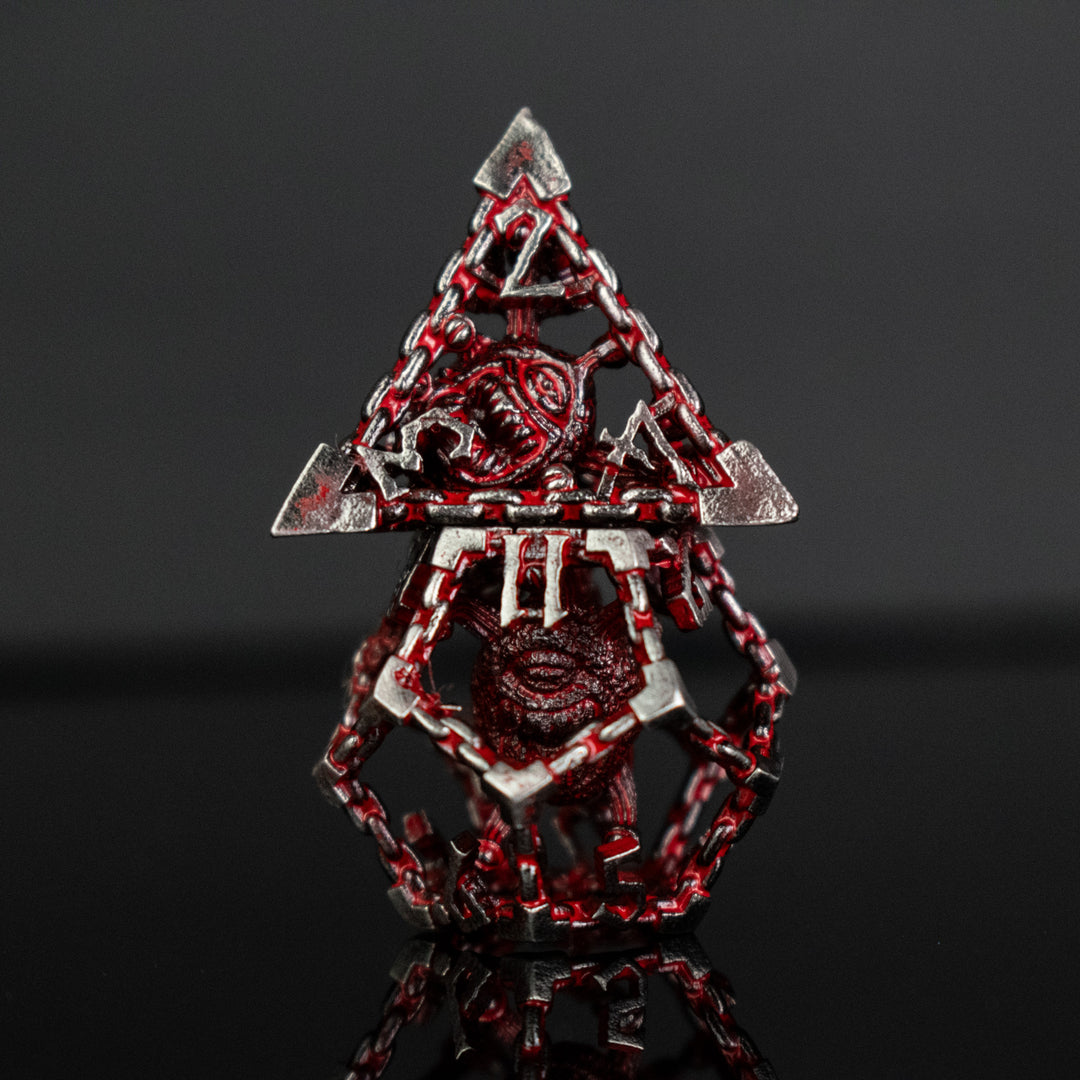 Silver and red hollow dice with beholders inside for tabletop gaming