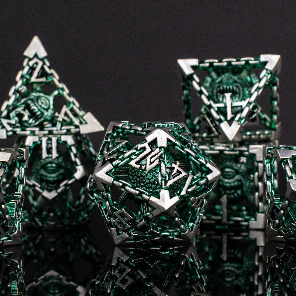 Close-up of metallic polyhedral dice with geometric designs on a dark background