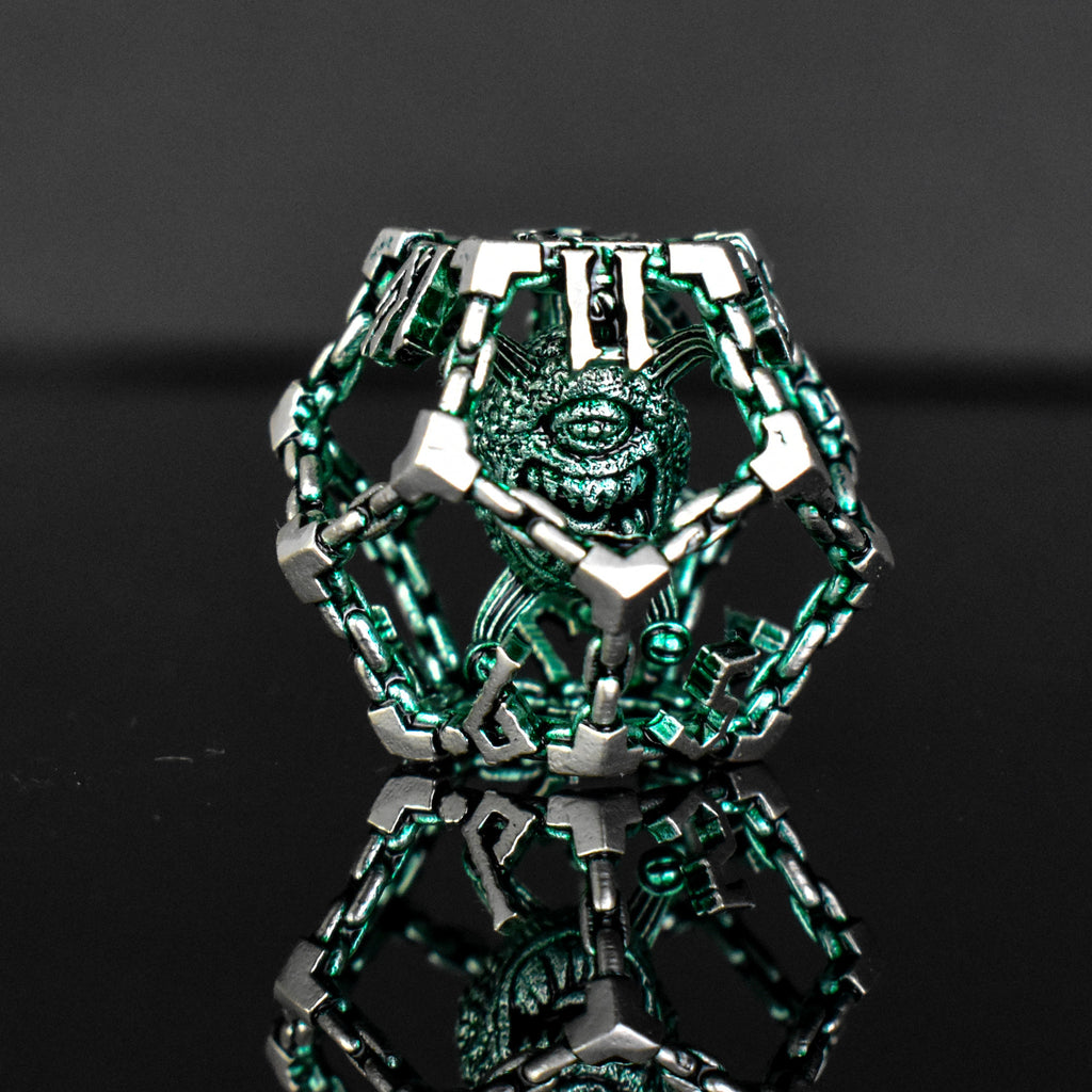 A set of hollow metal dice in green and silver colors with embossed numbers, reflecting on a black surface.