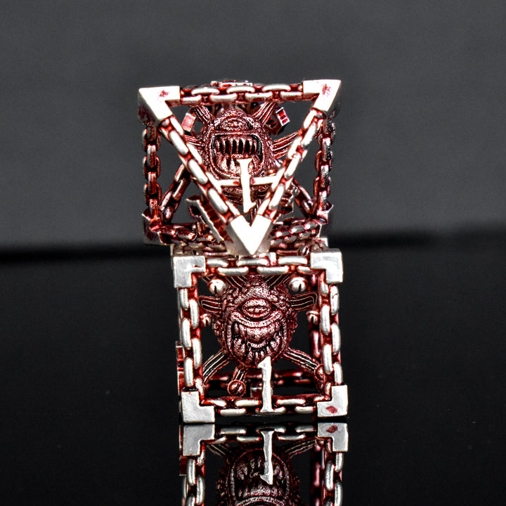 A set of hollow metal dice in red and silver, including various shapes such as a d4, d6, d8, d10, d12, and d20, displayed on a reflective surface.