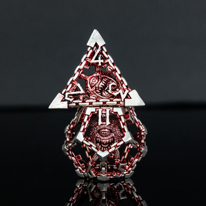 A set of hollow metal dice in red and silver, including various shapes such as a d4, d6, d8, d10, d12, and d20, displayed on a reflective surface.