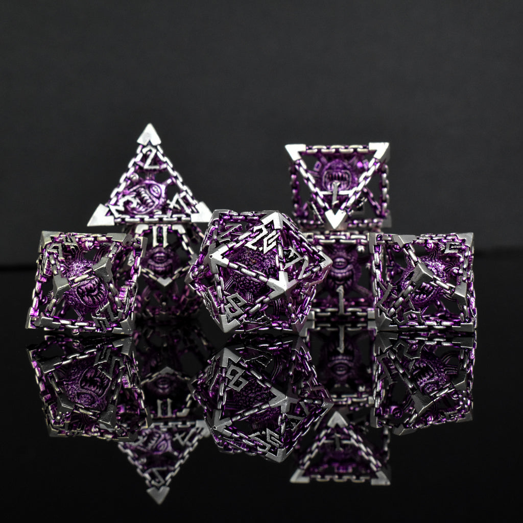 A set of hollow metal dice in purple and silver colors with embossed numbers and a beholder inside, reflecting on a shiny surface.