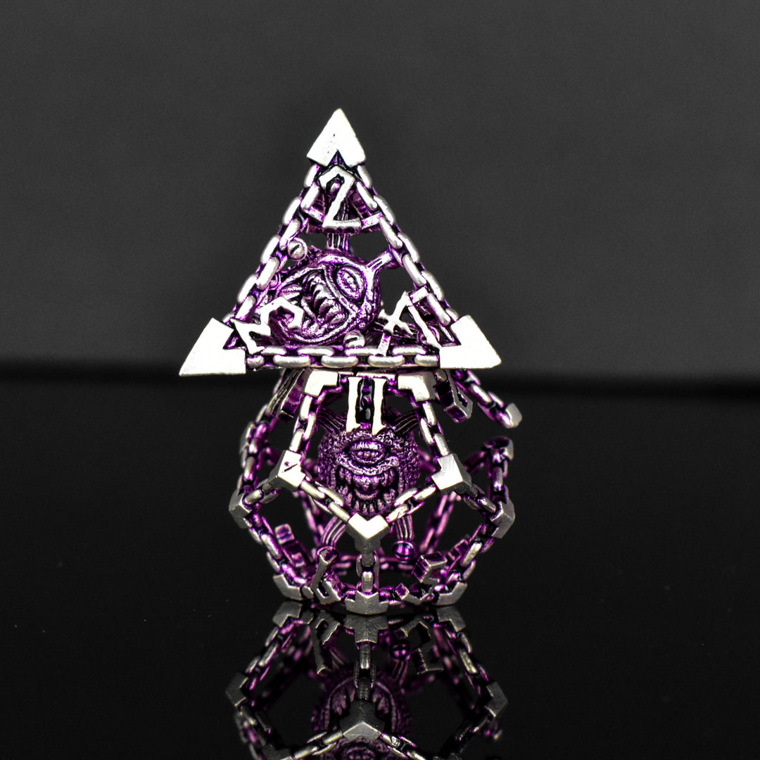 A set of hollow metal dice in purple and silver colors with embossed numbers and a beholder inside, reflecting on a shiny surface.