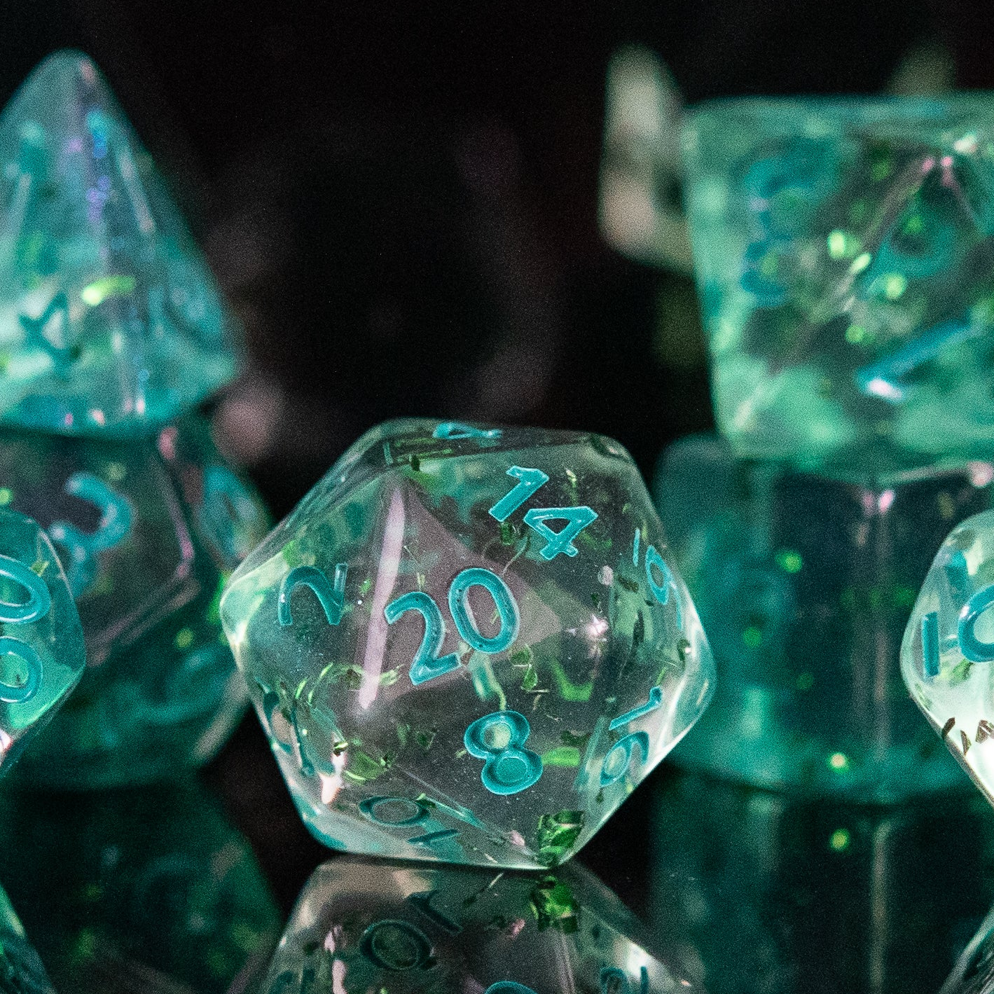 Green polyhedral dice with numbers on a reflective surface