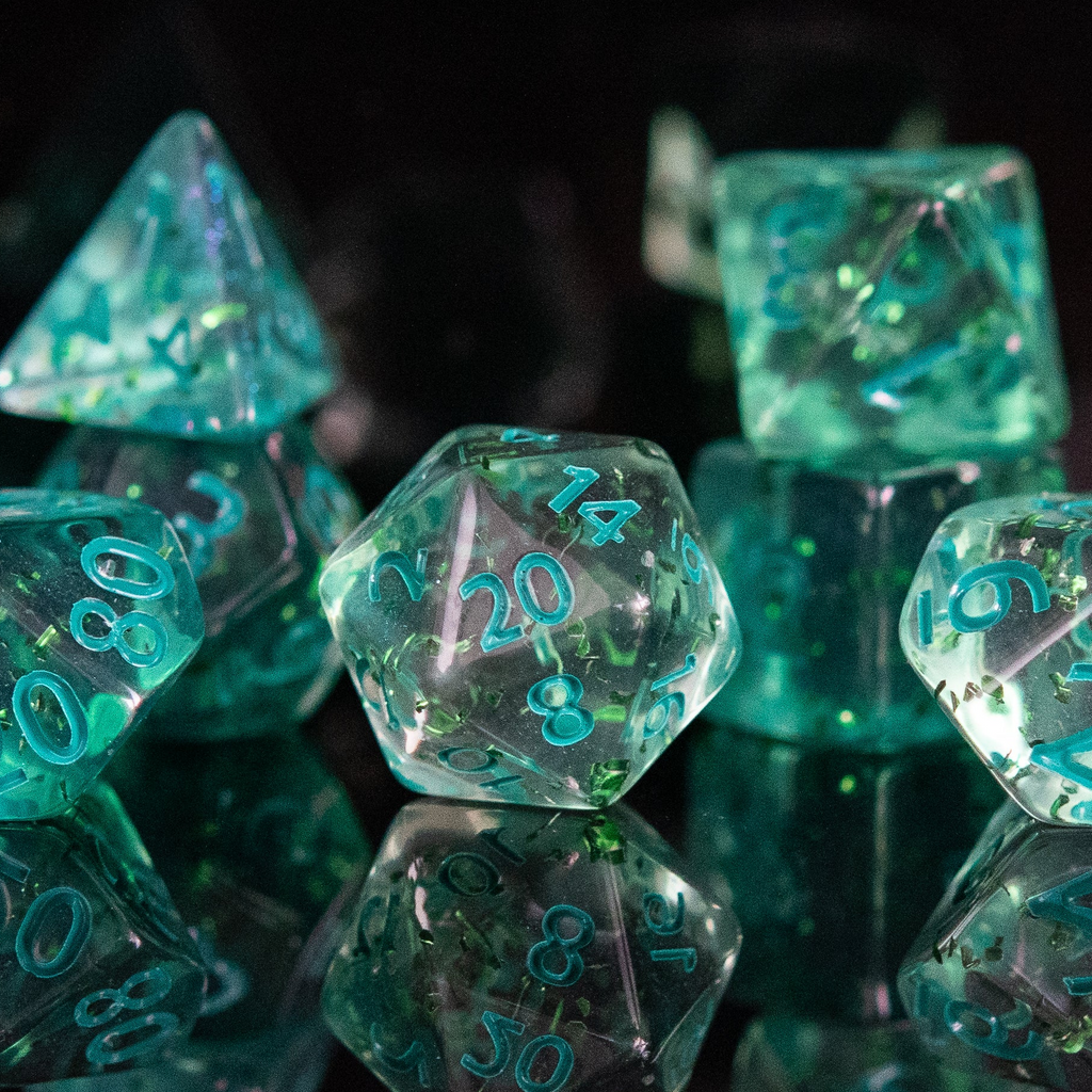 Green polyhedral dice with numbers on a reflective surface