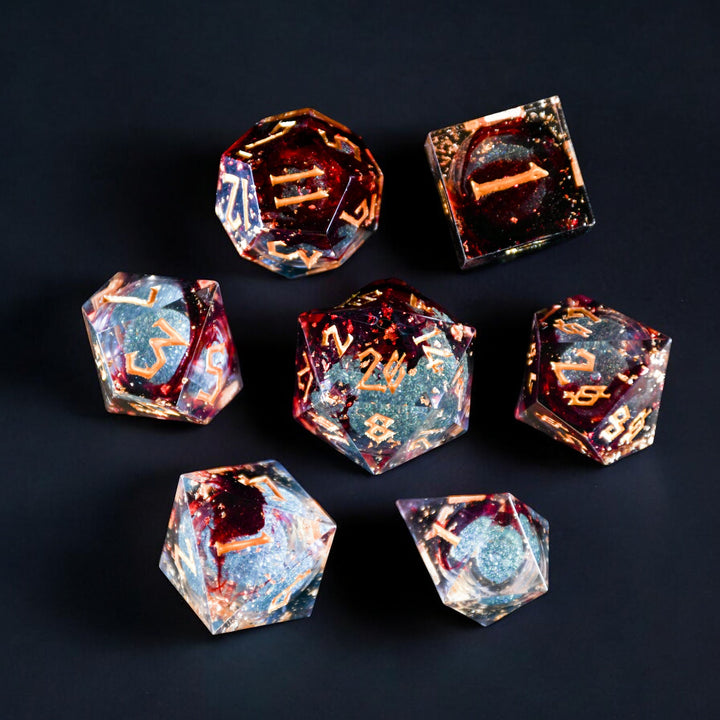 A set of hand-crafted, multicolored resin liquid core dice with engraved numbers, embedded with glitter, displayed on a dark background.
