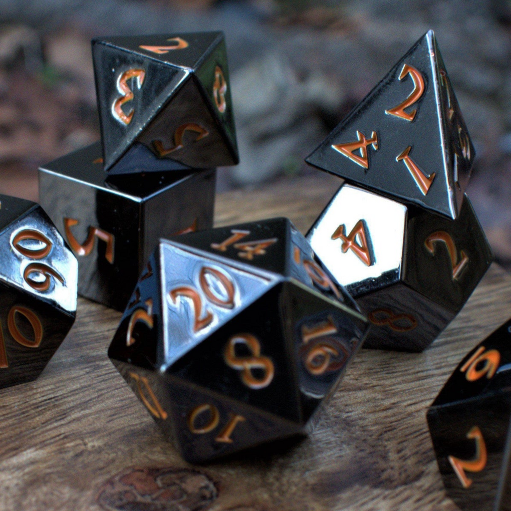 A set of black metal dnd dice with orange numbers, including various shapes such as a d4, d6, d8, d10, d12, and d20, displayed on a wooden surface.