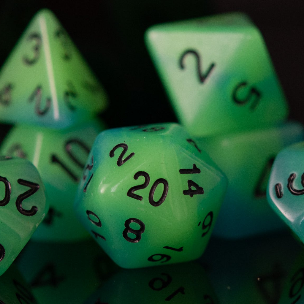 Green polyhedral dice with numbers on a dark background