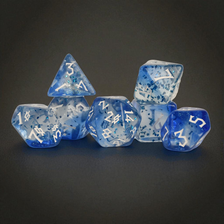 a set of white and blue acrylic dice with blue glitter chunks inside and white numbering for ttrpg