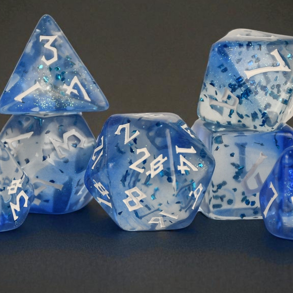 a set of white and blue acrylic dice with blue glitter chunks inside and white numbering for ttrpg