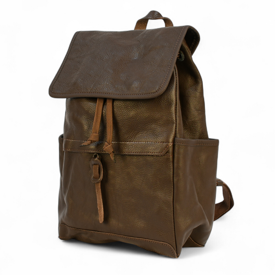 Brown leather modern rugged backpack in a forest setting