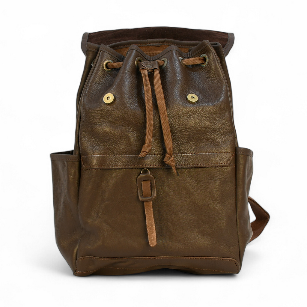 Brown leather modern rugged backpack in a forest setting
