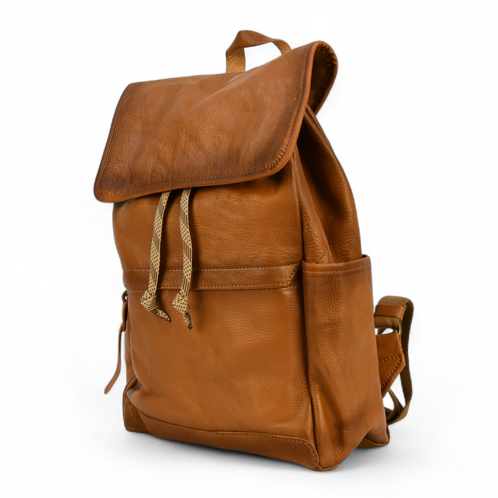 Brown leather modern rugged backpack on a forest floor