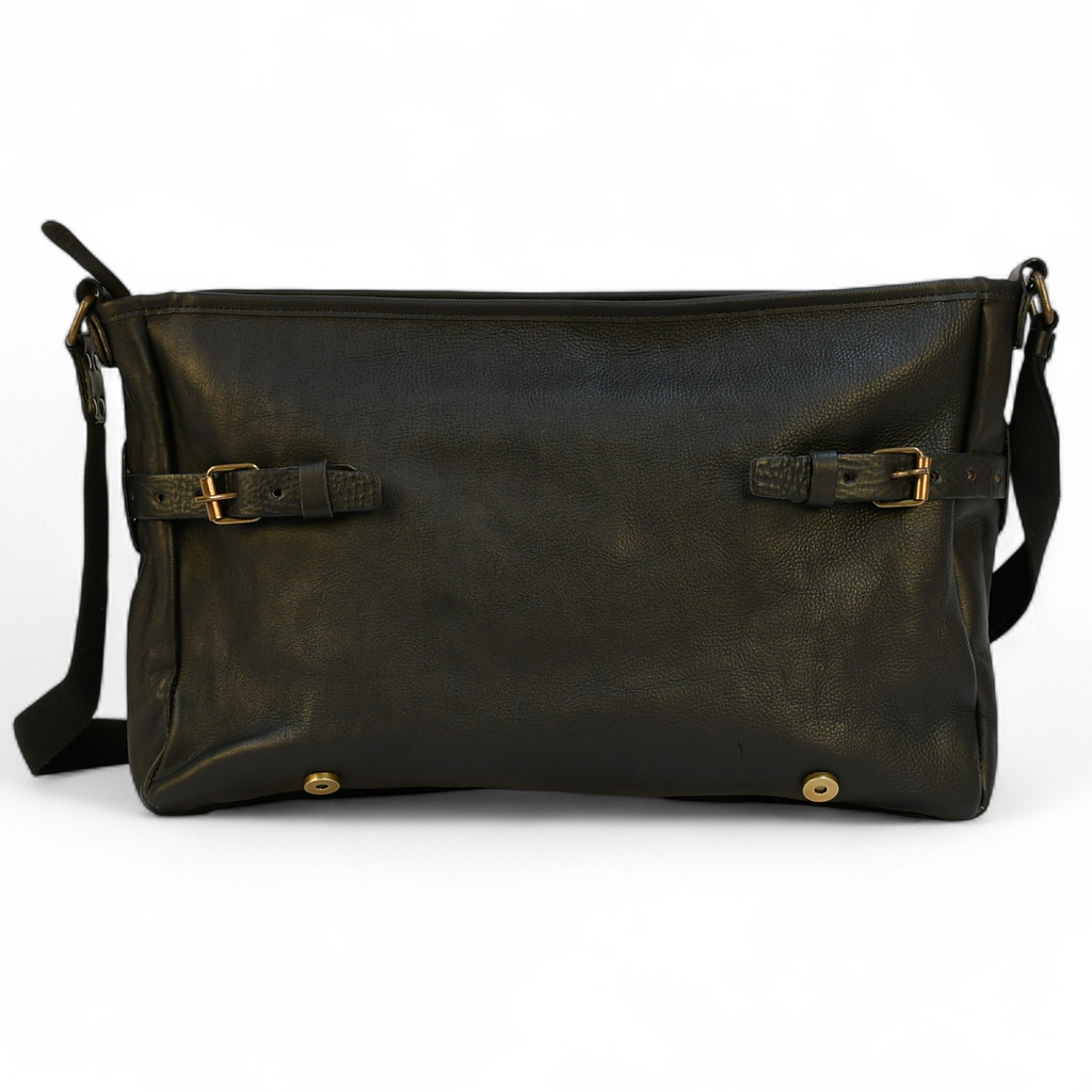 Black leather modern rugged messenger bag on a wooden surface