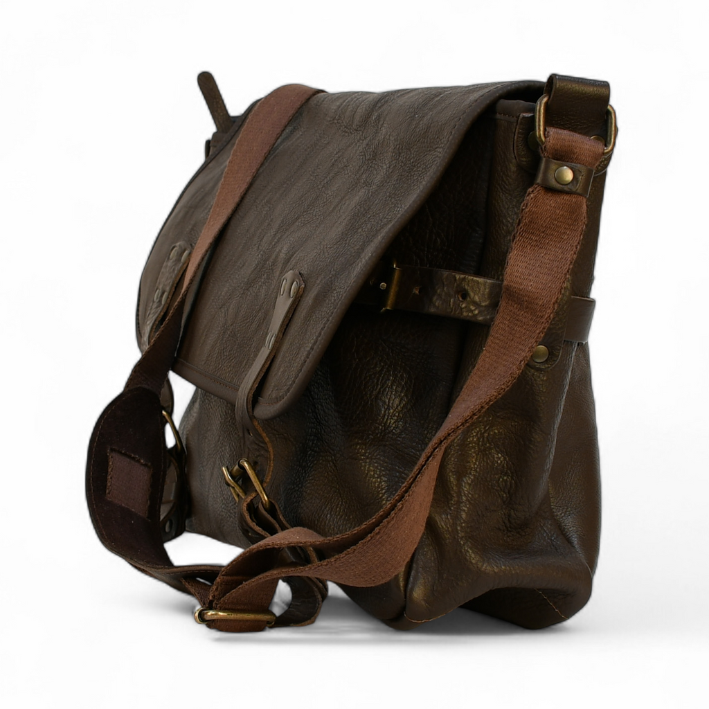 Brown leather bag with a strap on a white background