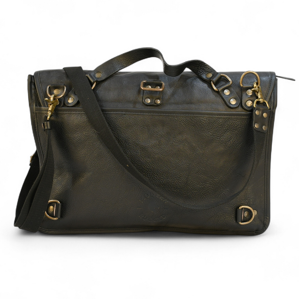 Vintage-style modern rugged leather briefcase bag on a wooden surface with bookshelf in the background