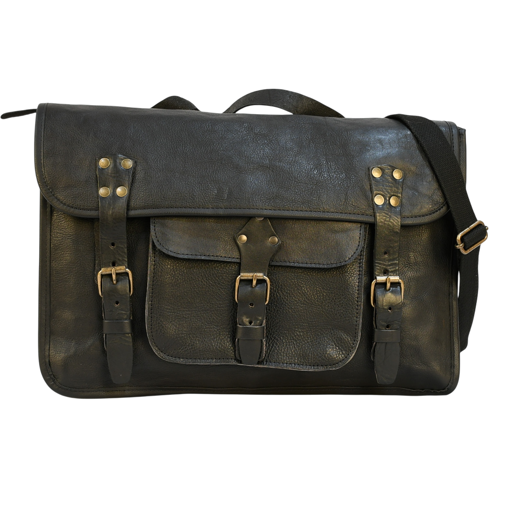 Vintage-style modern rugged leather briefcase bag on a wooden surface with bookshelf in the background