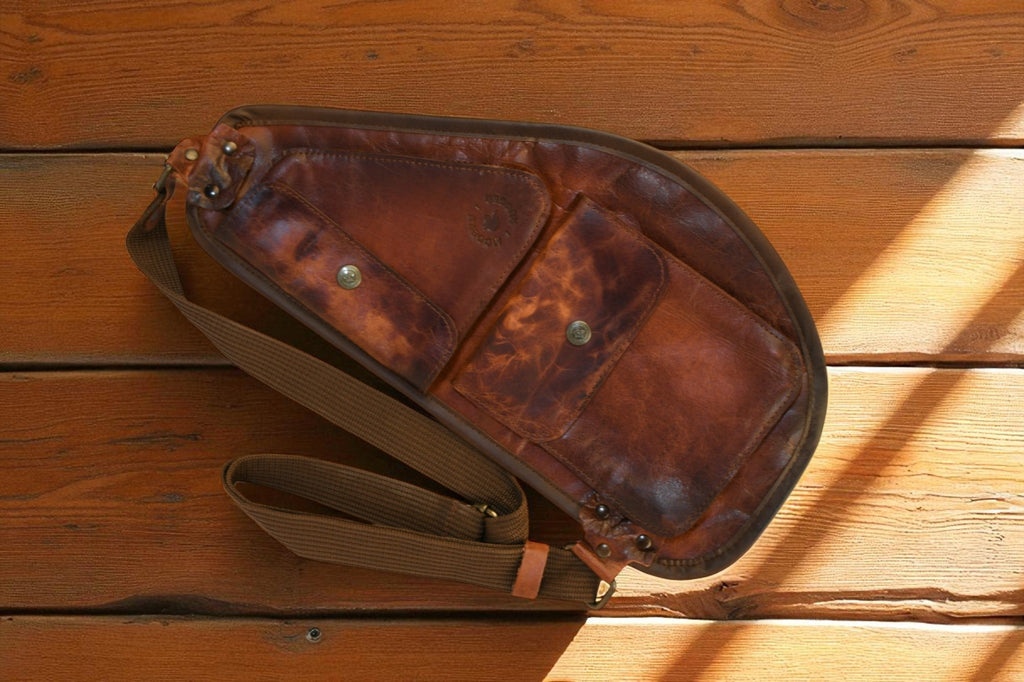 Brown leather bag on a wooden surface