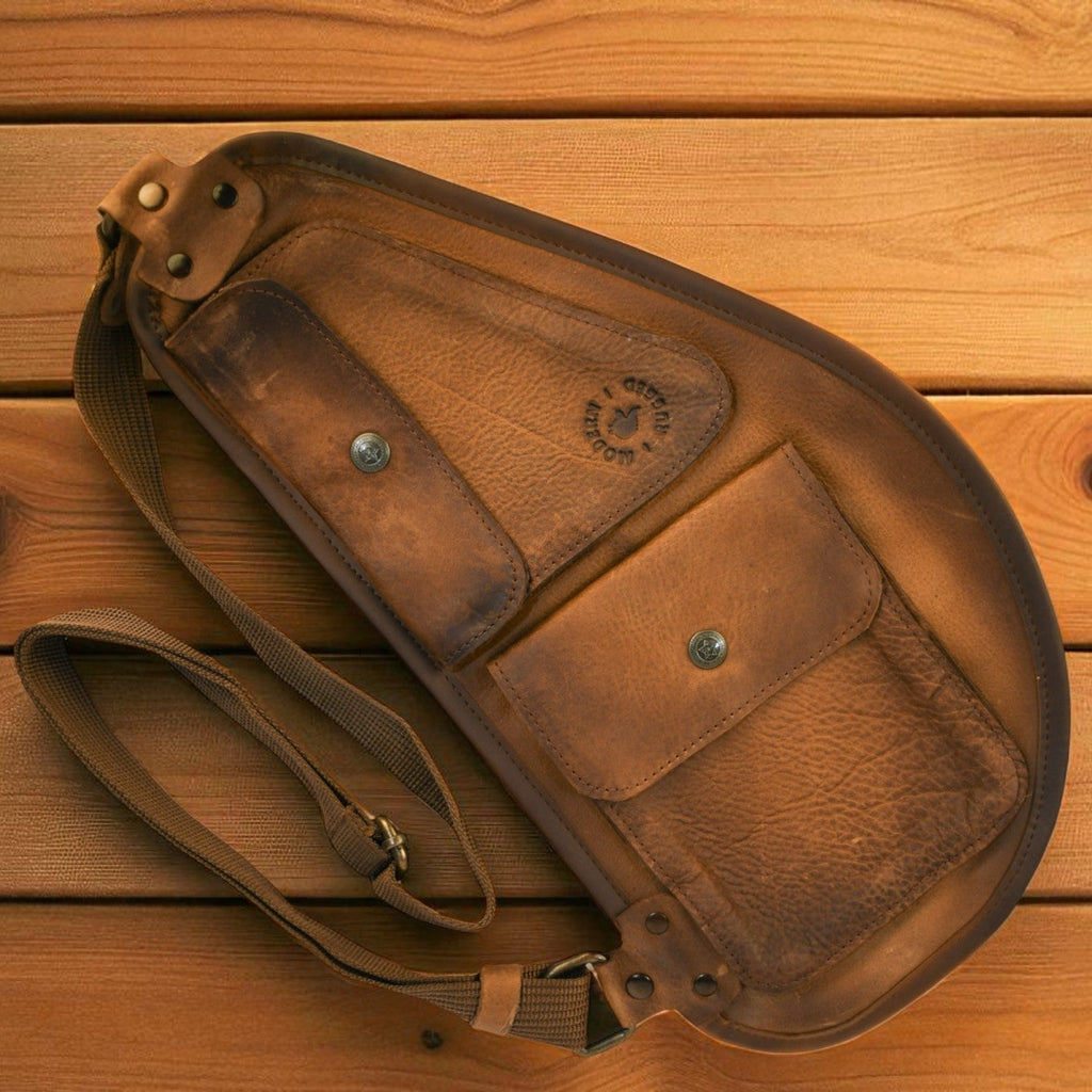 Brown leather bag on a wooden surface