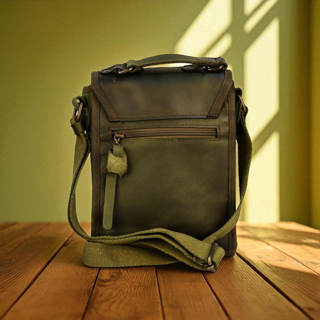Green leather bag on a wooden surface with a green wall in the background