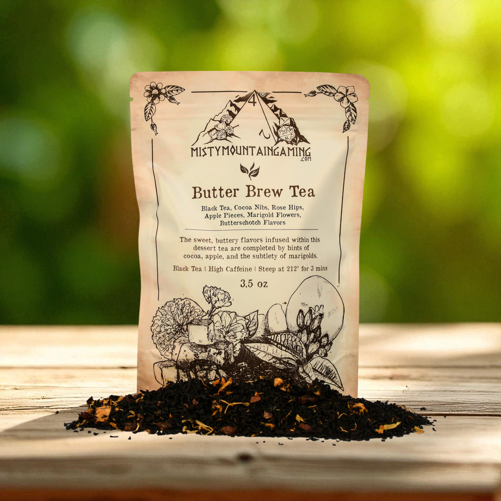 Butter Brew Tea package from Misty Mountain Gaming on a wooden surface with tea leaves.