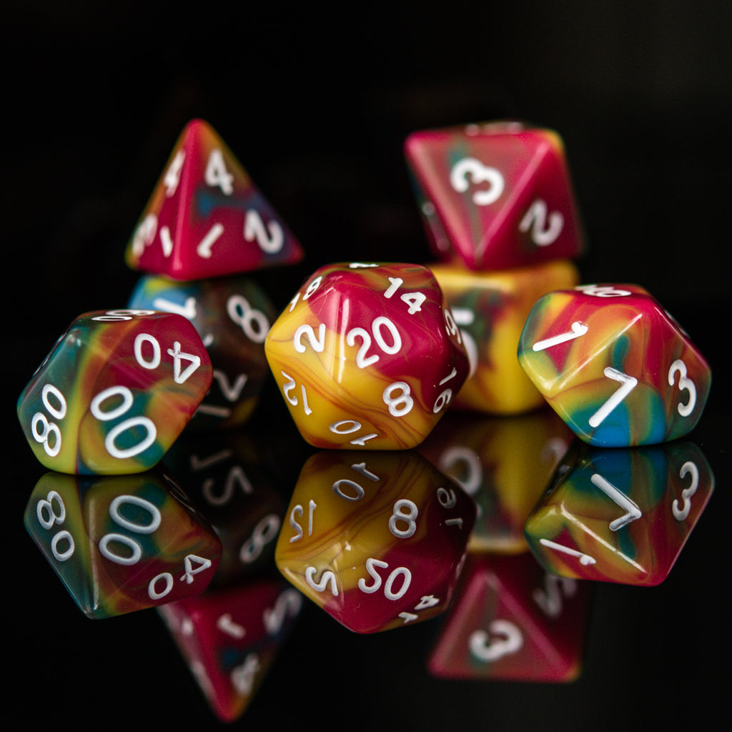 A set of multicolored acrylic dice with engraved numbers, displayed on a reflective surface.