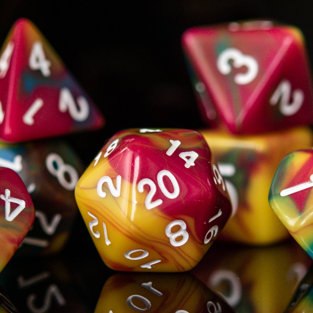 A set of multicolored acrylic dice with engraved numbers, displayed on a reflective surface.