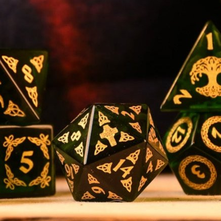 a set of polyhedral Celtic Green Glass Dice with golden numbering and celtic designs